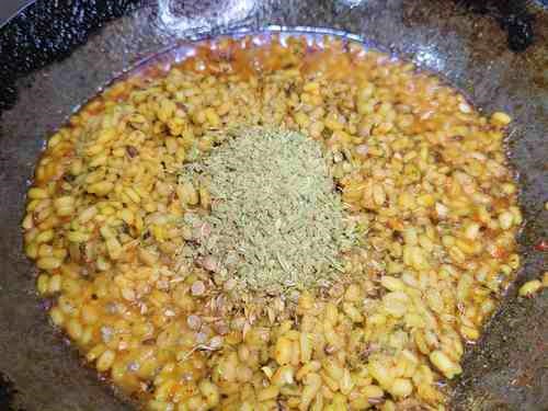 adding spices to kachori filling